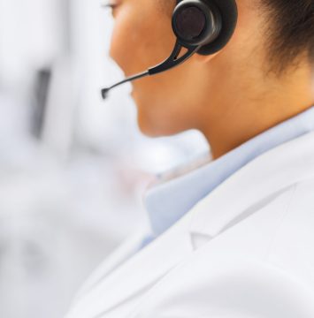 female helpline operator with headphones business, communication and call center concept - female helpline operator with headphones